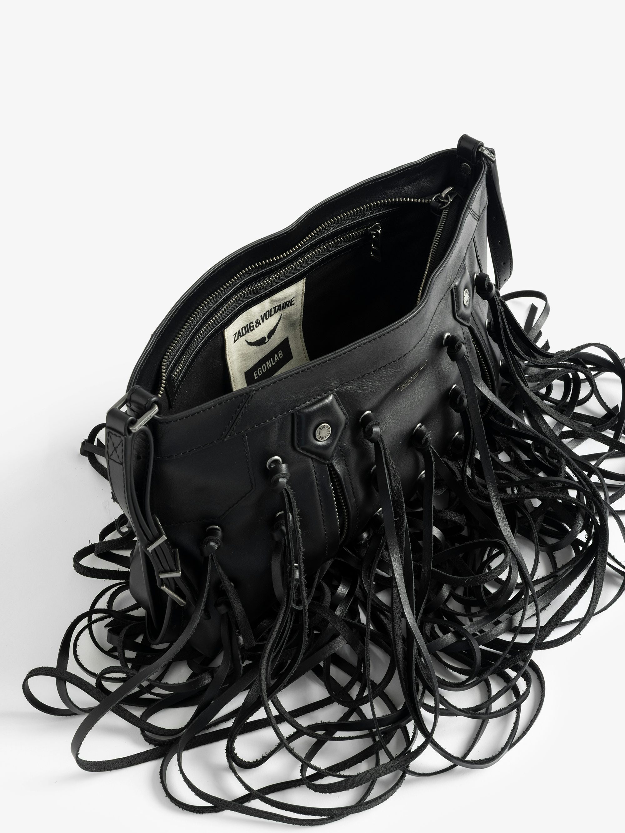 Sunny Moody Fringes Bag - A rebellion in motion. The Sunny Moody Fringes bag is reimagined with EGONlab’s signature edge—crafted in smooth black leather and slashed with dramatic fringe that moves with attitude. Western soul meets underground spirit in this bold, sculptural piece. Wear it slung over the shoulder or crossbody—just don’t expect to go unnoticed.